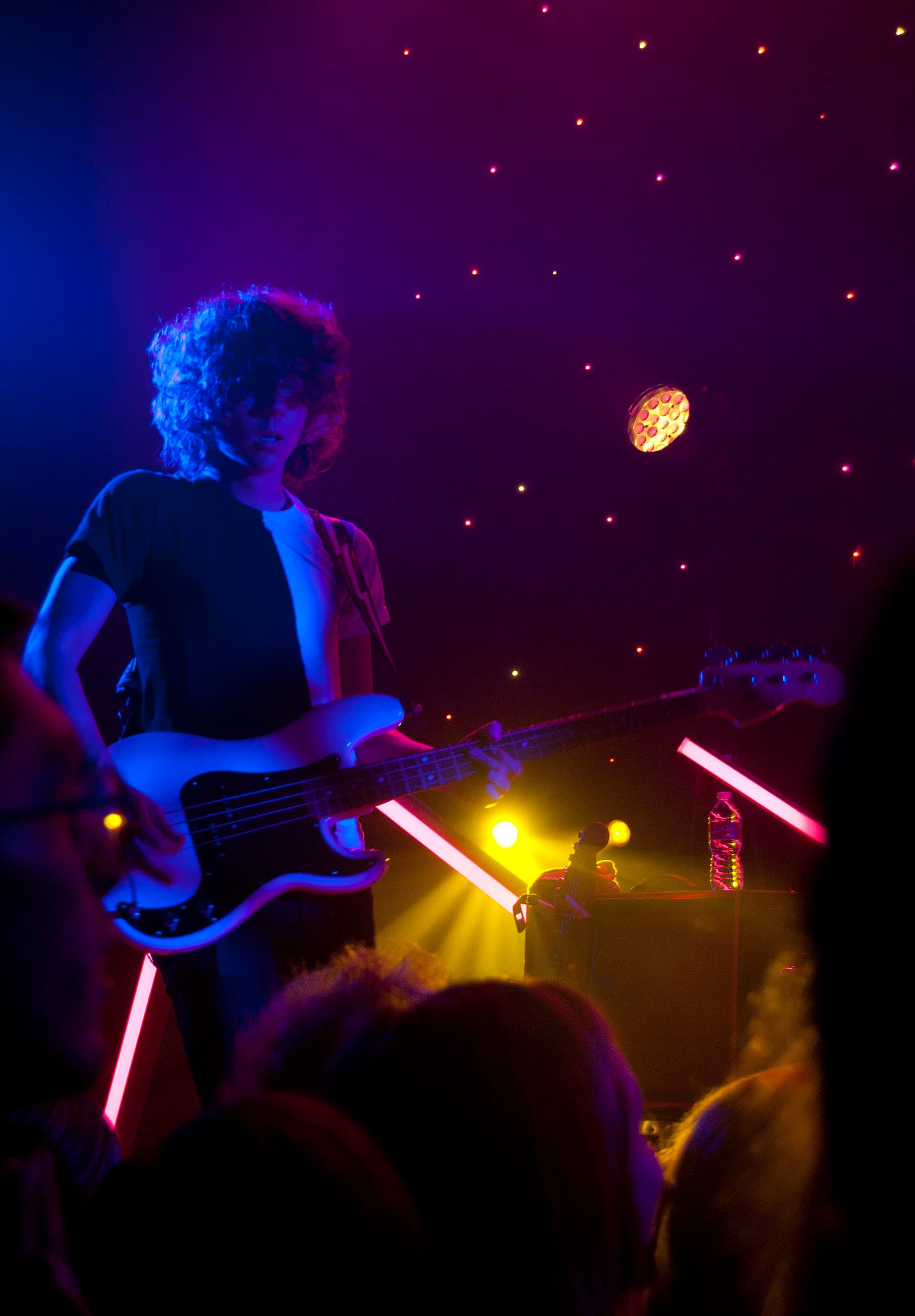 Musician under blue stage light — atmospheric stand-in, not an event photo