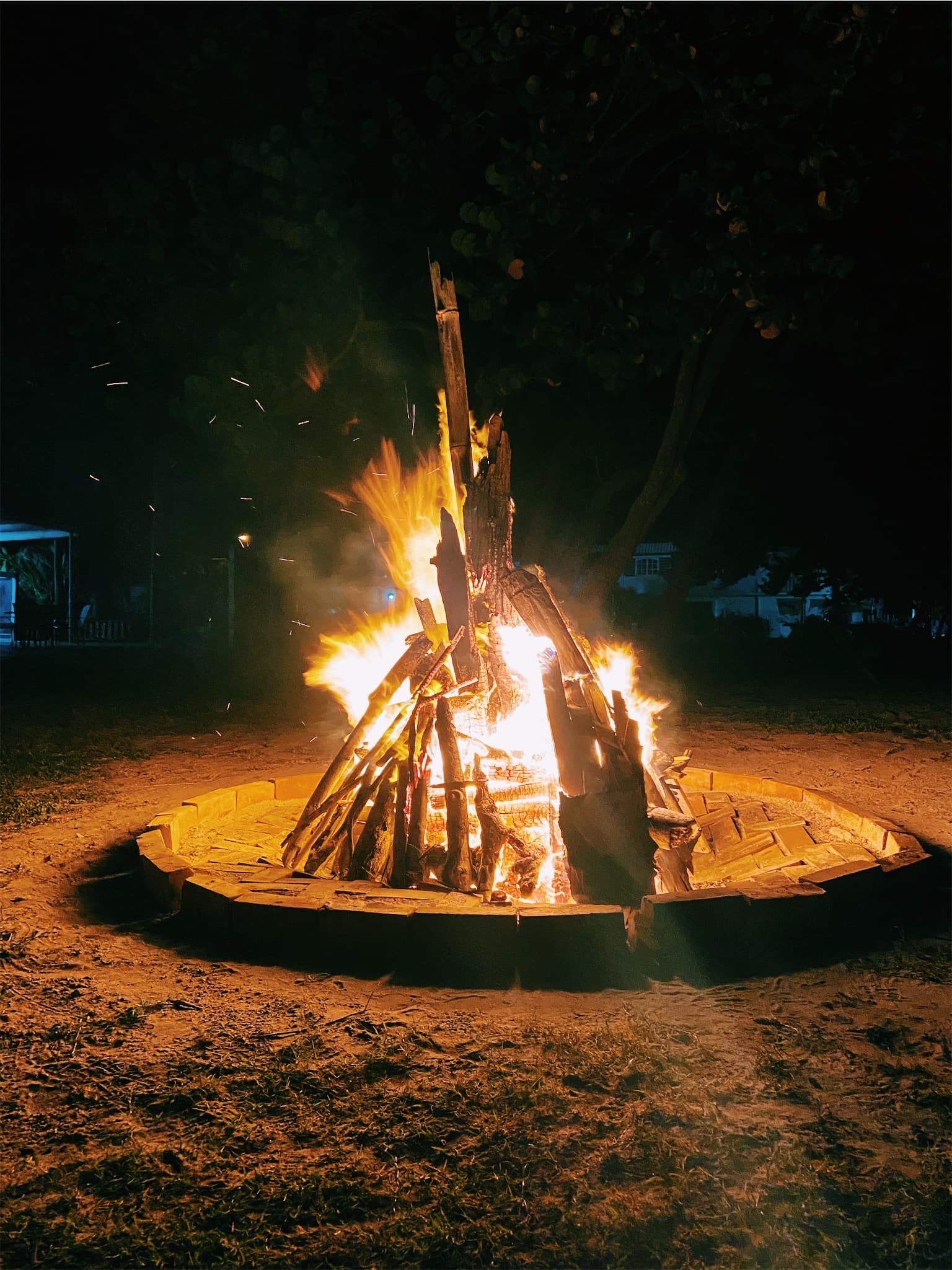 Beach bonfire at night — atmospheric stand-in, not an event photo